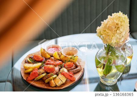 Grilled Sausages with Vegetables and Dipping Sauces 136168365