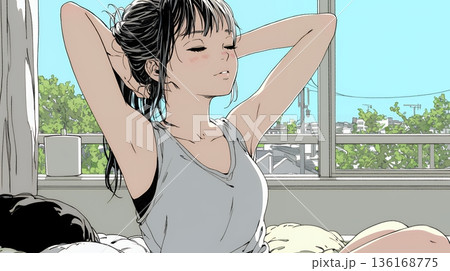 朝の目覚ましを止めて伸びをしている若い女性