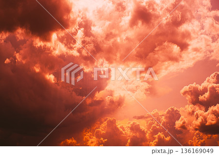 Dramatic sunset sky with fiery orange clouds and sunlight rays 136169049