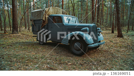 German military cargo truck parked in forest during World War II 136169051
