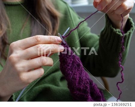 woman knits wool clothes knitting needles. skills of making clothes from yarn, hobbies meditation. 136169251