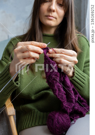 woman knits wool clothes knitting needles. skills of making clothes from yarn, hobbies meditation. 136169252
