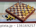 chessboard with golden and silver pieces isolated close-up 136169257
