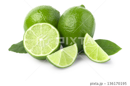Fresh green limes with slices and leaves on white Fresh green limes with slices and leaves on white 136170195