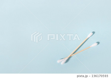 Two wooden cotton swabs for daily hygiene on blue background Two wooden cotton swabs for daily hygiene on blue background 136170593