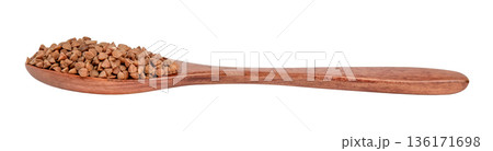 Buckwheat groats in a brown wooden spoon isolated on white background 136171698