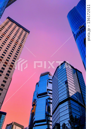 Glass facade building. Skyscraper Business tower on bright colors in sunset.  136172011