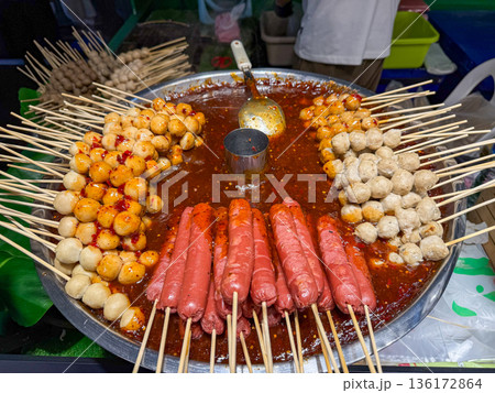 Asian street food skewers in spicy sauce 136172864