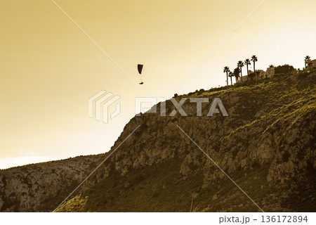 Paraglider flying in sky. 136172894