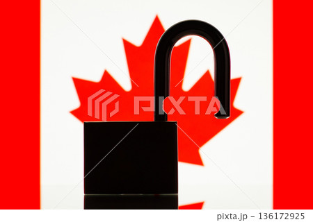 Black silhouette of open lock against flag of Canada. Reopen Canada country, freedom, easy pass of border concept Black silhouette of open lock against flag of Canada. Reopen Canada country, freedom, easy pass of border concept 136172925