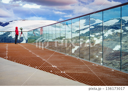 Tourist with camera on tripod in Norway nature 136173017