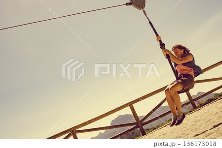 Adult woman having fun on zipline Adult woman having fun on zipline 136173018