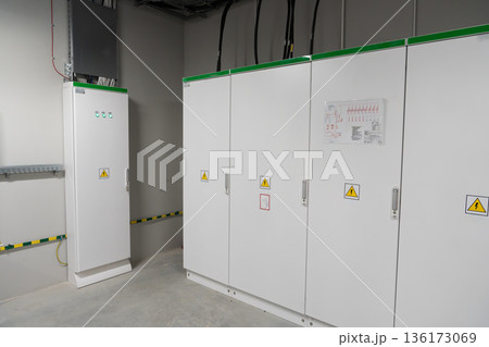 White electrical switchgear cabinets in industrial setting 136173069