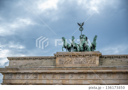 Berlin, germany, august 12, 2023. Brandenburg gate quadriga chariot featuring goddess victoria driving four horses and iron cross on top, iconic berlin landmark 136173850