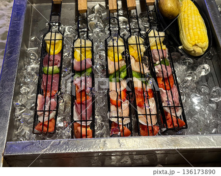 Raw Meat Skewers on Ice Display 136173890