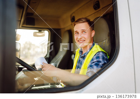 Truck driver job. Logistics - proud driver or forwarder on truck and trailer, on transshipment point Truck driver job. Logistics - proud driver or forwarder on truck and trailer, on transshipment point 136173978