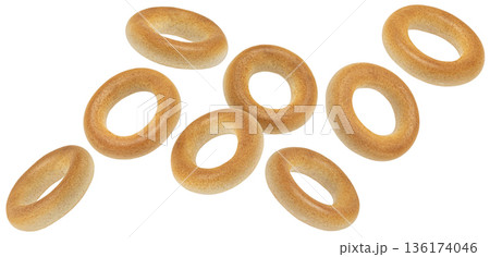 Falling round bagel drying snacks isolated on white background, full depth of field Falling round bagel drying snacks isolated on white background, full depth of field 136174046