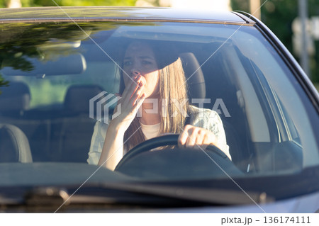 Scared woman driver look in rear view mirror frightened of car accident. Stressed girl in vehicle Scared woman driver look in rear view mirror frightened of car accident. Stressed girl in vehicle 136174111