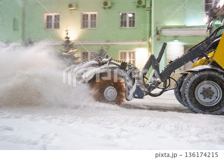 Cleaning snow from road. Snowplow tractor in city blow snow from street for transport traffic safety 136174215