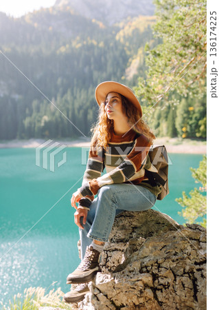 Adventure woman feeling happy among amazing mountains, forest and lake, enjoy the nature landscape 136174225