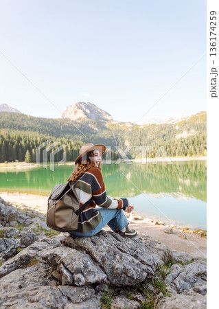 Adventure woman feeling happy among amazing mountains, forest and lake, enjoy the nature landscape 136174259