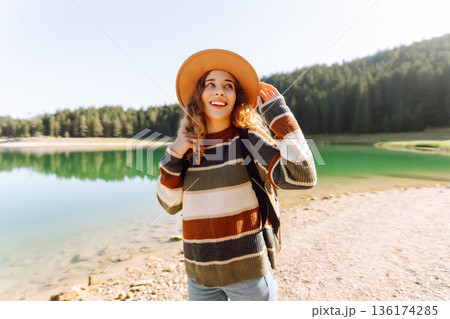 Adventure woman feeling happy among amazing mountains, forest and lake, enjoy the nature landscape Adventure woman feeling happy among amazing mountains, forest and lake, enjoy the nature landscape 136174285