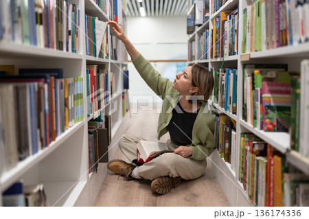 Woman chief editor at major publishing house in casual clothes working on best-seller famous author. Woman chief editor at major publishing house in casual clothes working on best-seller famous author. 136174336