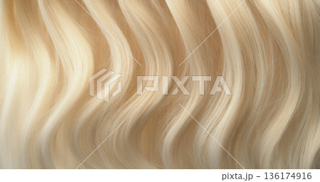 Close-up abstract texture of flowing blonde hair forming soft natural waves. Elegant curves, fine strands and warm tones create a luxurious beauty background ideal for cosmetic, fashion or haircare Close-up abstract texture of flowing blonde hair forming soft natural waves. Elegant curves, fine strands and warm tones create a luxurious beauty background ideal for cosmetic, fashion or haircare 136174916