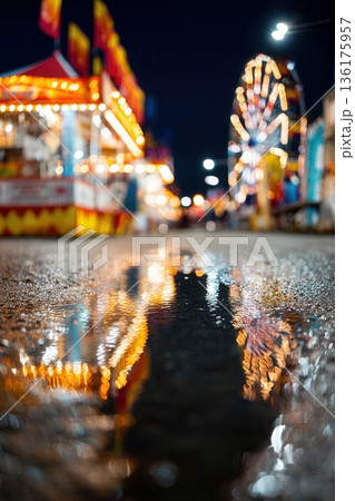 Rain puddle reflecting carnival lights at night 136175957