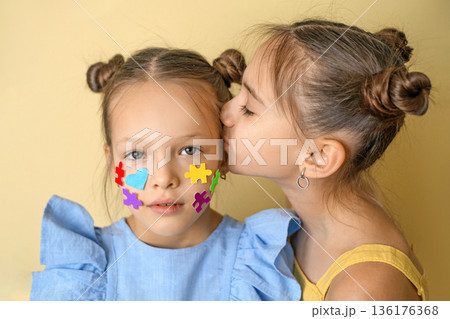 Children showing puzzle symbols and care as a sign of autism awareness, inclusion, acceptance and emotional support. Social equality and kindness concept. 136176368