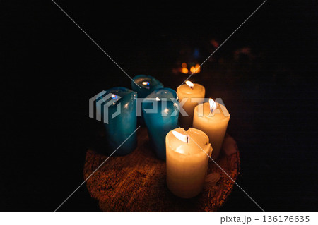 Lit Candles on Wooden Surface in Dark Atmosphere 136176635