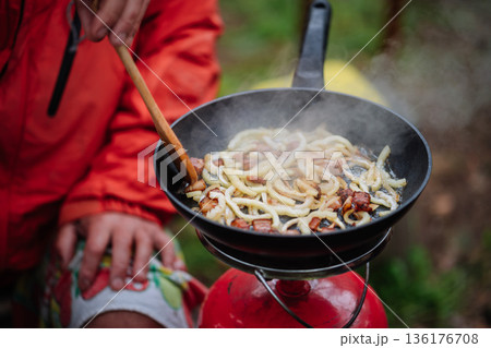 Outdoor Cooking Lard and Onion on Camping Stove 136176708