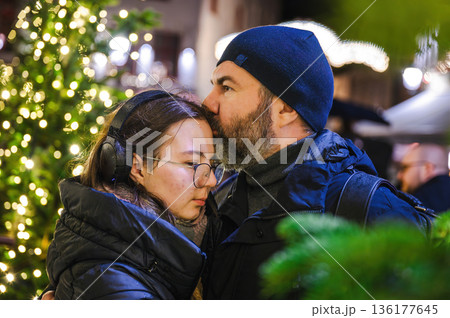 Cheerful Christmas Girl with Her Father and Festive Lights 136177645