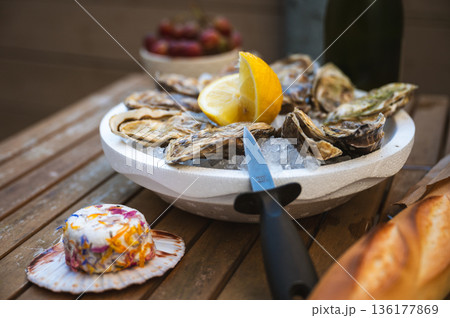 Fresh Raw Oysters with Citron, Baguette, Butter, and Cider 136177869