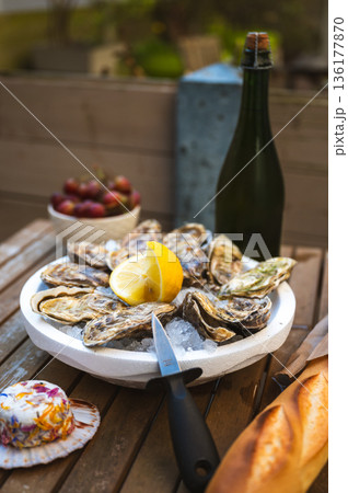 Fresh Raw Oysters with Citron, Baguette, Butter, and Cider 136177870