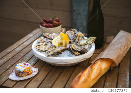Fresh Raw Oysters with Citron, Baguette, Butter, and Cider 136177873