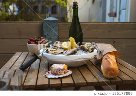 Fresh Raw Oysters with Citron, Baguette, Butter, and Cider 136177899