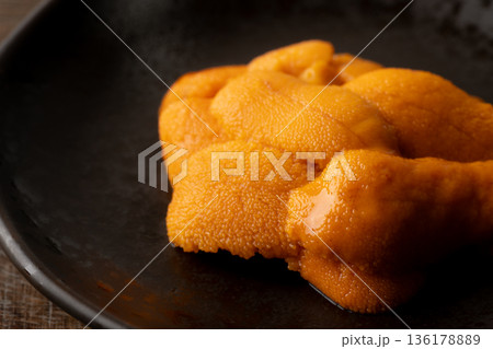 お皿に載せた生のエゾバフンウニのクローズアップ お皿に載せた生のエゾバフンウニのクローズアップ 136178889