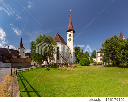 Historic church in Interlaken with green lawn and alpine backdrop Historic church in Interlaken with green lawn and alpine backdrop 136179192