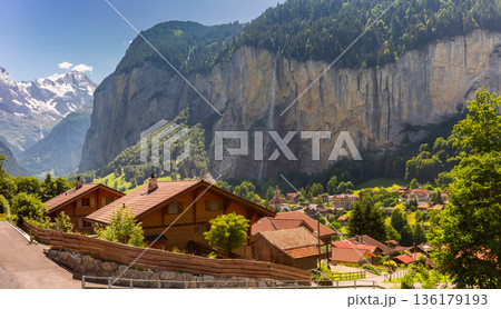 Lauterbrunnen valley with alpine village and cliffs in summer Lauterbrunnen valley with alpine village and cliffs in summer 136179193