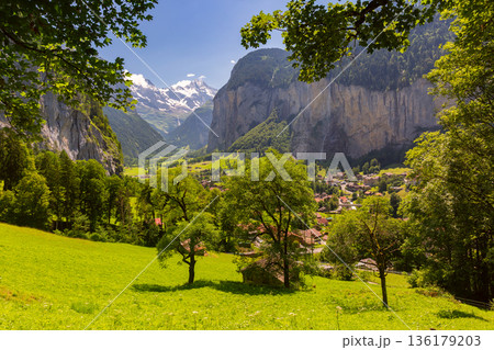 Lauterbrunnen valley with alpine village and cliffs in summer Lauterbrunnen valley with alpine village and cliffs in summer 136179203