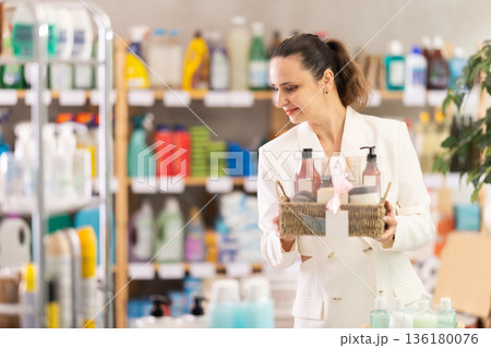 Adult woman buyer chooses cosmetics gift set 136180076