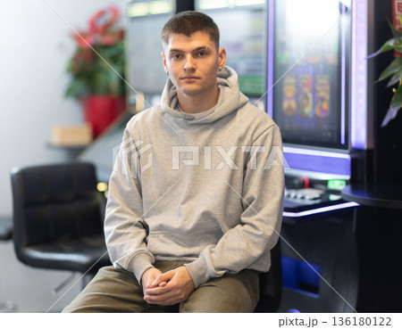 Guy administrator or visitor of slot machine room 136180122