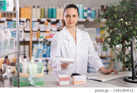 Woman pharmacist offers medication drug remedy Woman pharmacist offers medication drug remedy 136180412