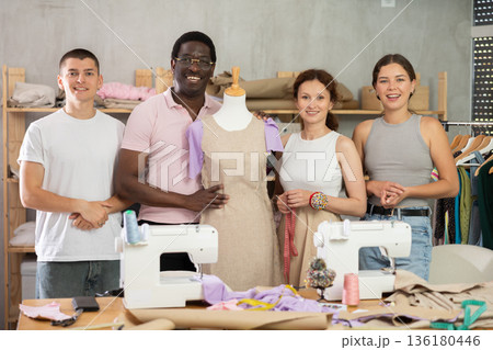 Group of students next to mannequin presents an intermediate version of product Group of students next to mannequin presents an intermediate version of product 136180446
