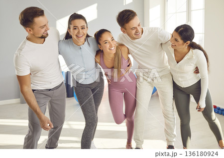 Group of athletes hugging looking into camera smiling and posing. Athletes embody spirit of teamwork and support bond shared among athletes Friendship teamwork mutual encouragement in sports. Group of athletes hugging looking into camera smiling and posing. Athletes embody spirit of teamwork and support bond shared among athletes Friendship teamwork mutual encouragement in sports. 136180924