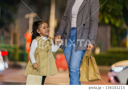 child girl and mother with shopping bag and sightseeing in Bangkok city at night 136181213