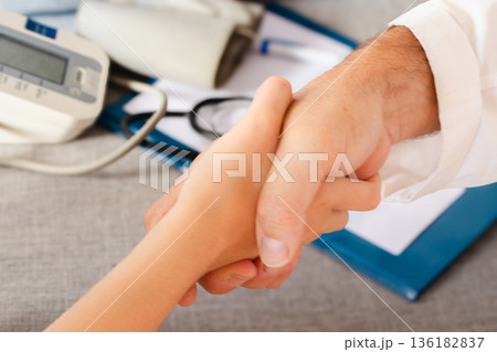 Doctor and patient hands shaking, conveying trust and understanding in a medical consultation .World Day for the Prevention of Cardiovascular Diseases Doctor and patient hands shaking, conveying trust and understanding in a medical consultation .World Day for the Prevention of Cardiovascular Diseases 136182837