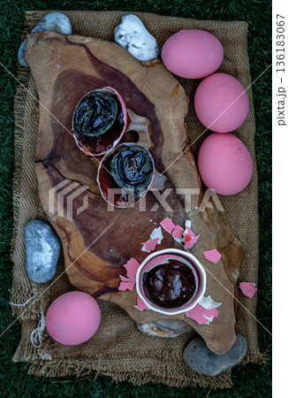 Pink Century eggs (Pidan Eggs) also known as preserved egg, hundred-year egg, thousand-year egg are a Chinese preserved food product and delicacy made by preserving duck, chicken in A Mixture of Ash, 136183067