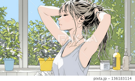 朝支度：洗面所で髪をまとめている若い女性